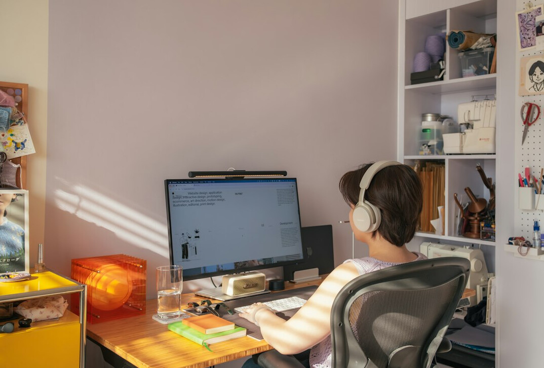 person coding at home desk