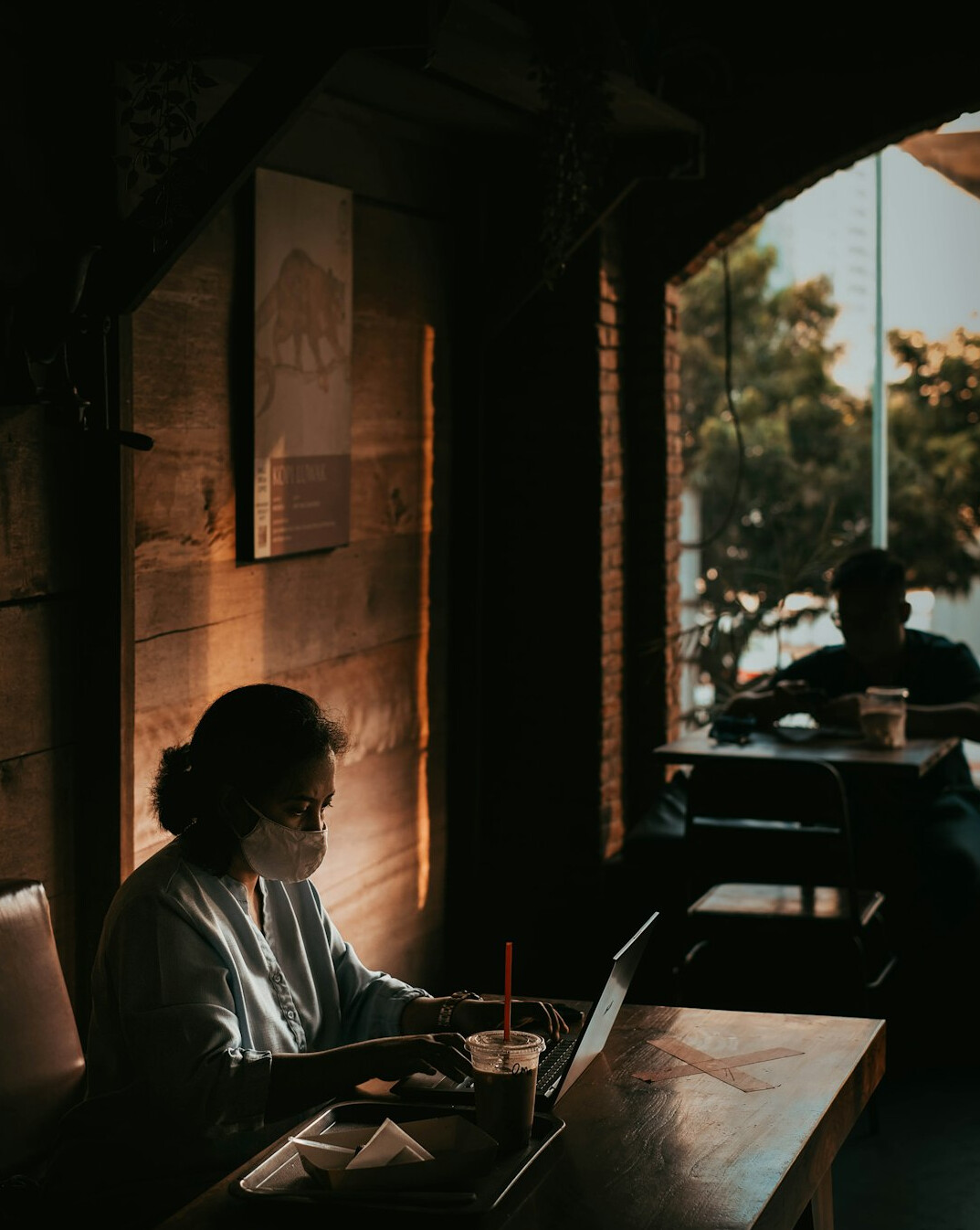 woman coding on laptop in cafe